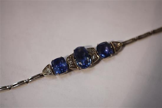 An early 20th century white metal and three stone sapphire bracelet,